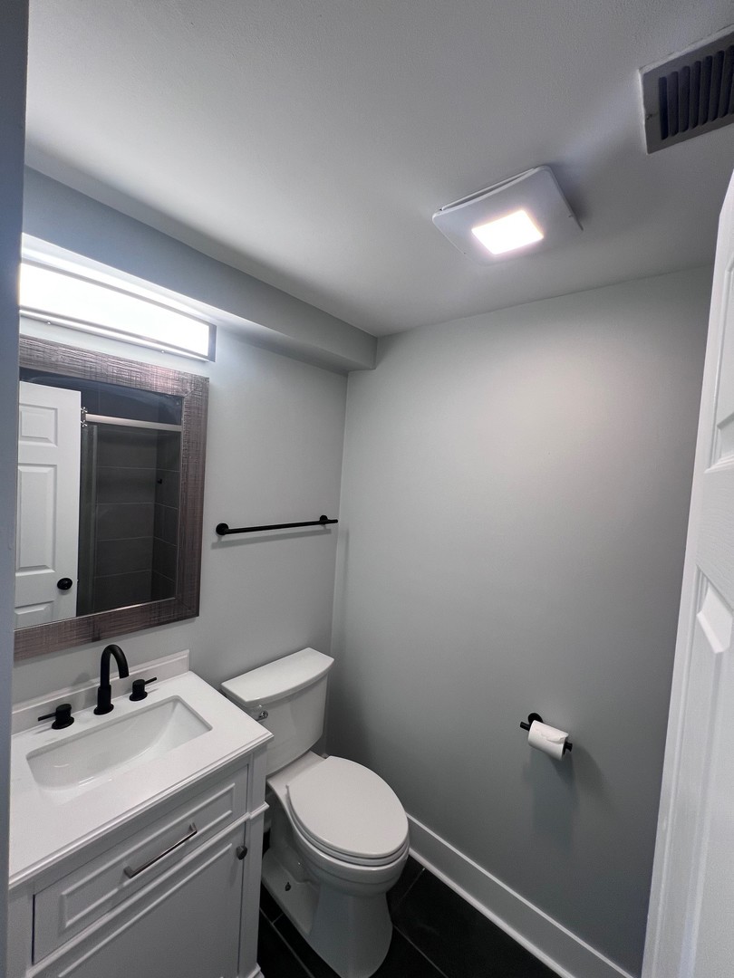 1170 Singleton Drive Roselle, IL 60172 - Photo 34 of 42 a bathroom with a sink a toilet and mirror