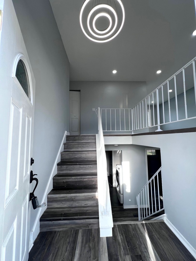 1170 Singleton Drive Roselle, IL 60172 - Photo 8 of 42 a view of entryway with wooden floor