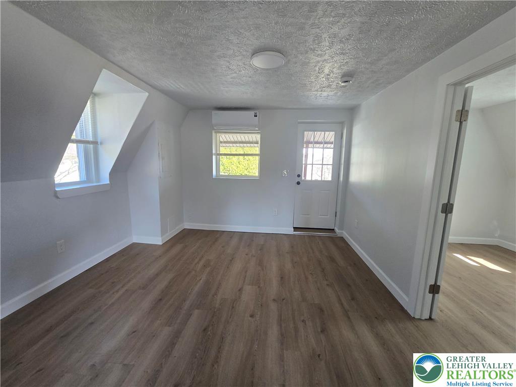 1731 West 8th Street Wind Gap, PA 18091 - Photo 5 of 13 an empty room with wooden floor and windows