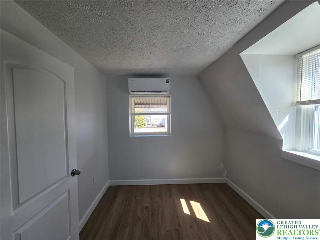 1731 West 8th Street Wind Gap, PA 18091 - Photo 8 of 13 an empty room with wooden floor and windows
