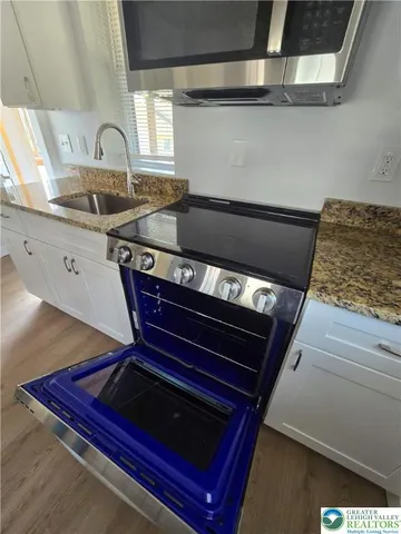 a kitchen with wooden cabinets and a stove top oven