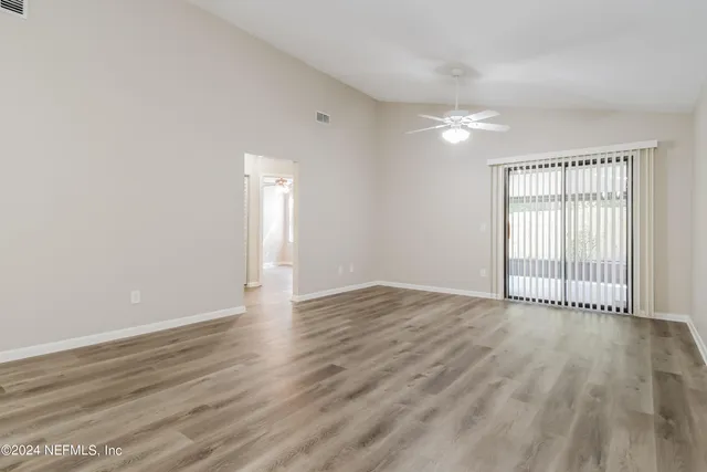 wooden floor in an empty room with a window