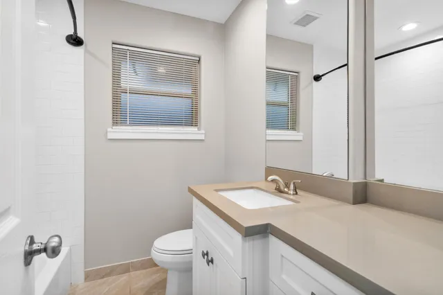 a bathroom with a sink toilet and vanity