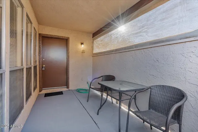 a view of a room that has a table and chairs in it