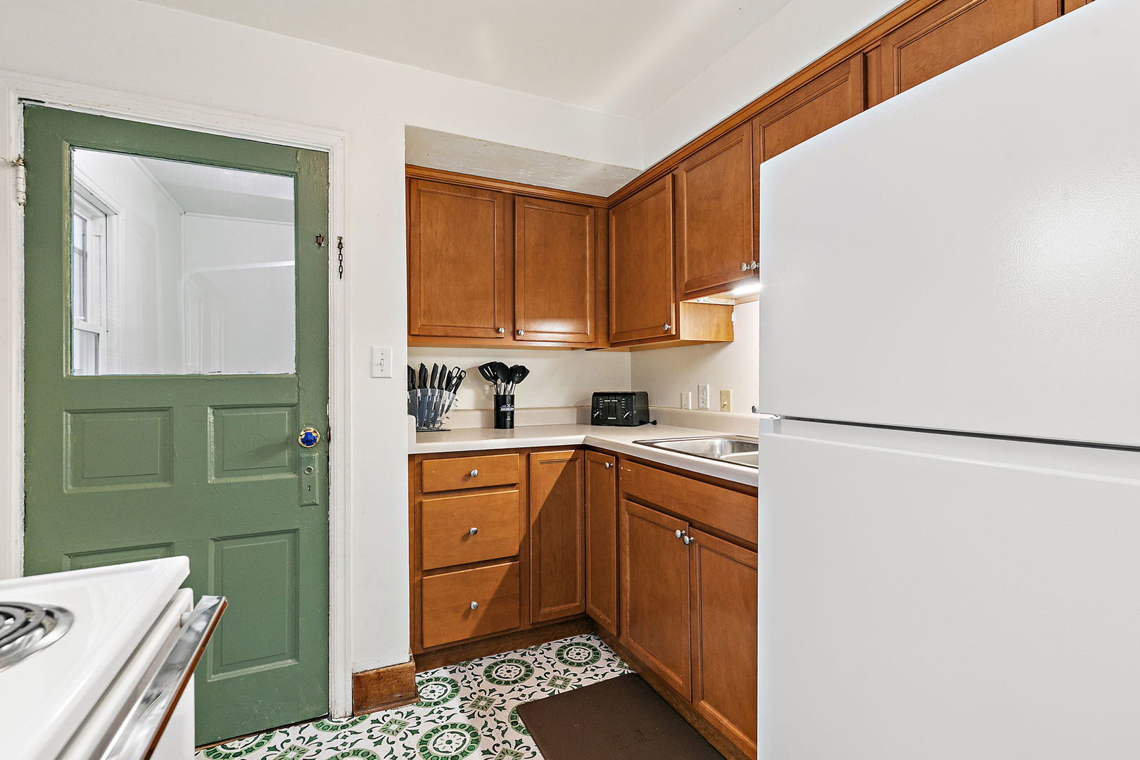 820 Lincoln Highway Rochelle, IL 61068 - Photo 10 of 27 a kitchen with a refrigerator sink and cabinets