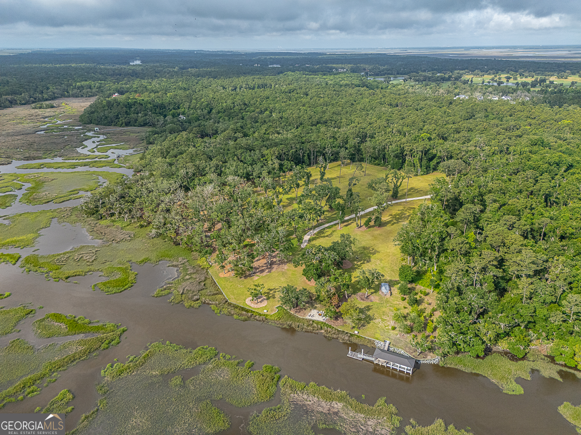 24 Carriage Drive St. Simons Island, GA 31522 - Photo 20 of 67 a view of a yard with an outdoor space