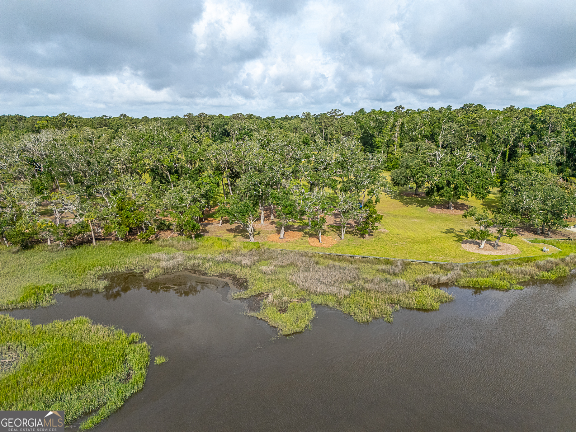24 Carriage Drive St. Simons Island, GA 31522 - Photo 26 of 67 a view of a lake with a mountain in the background