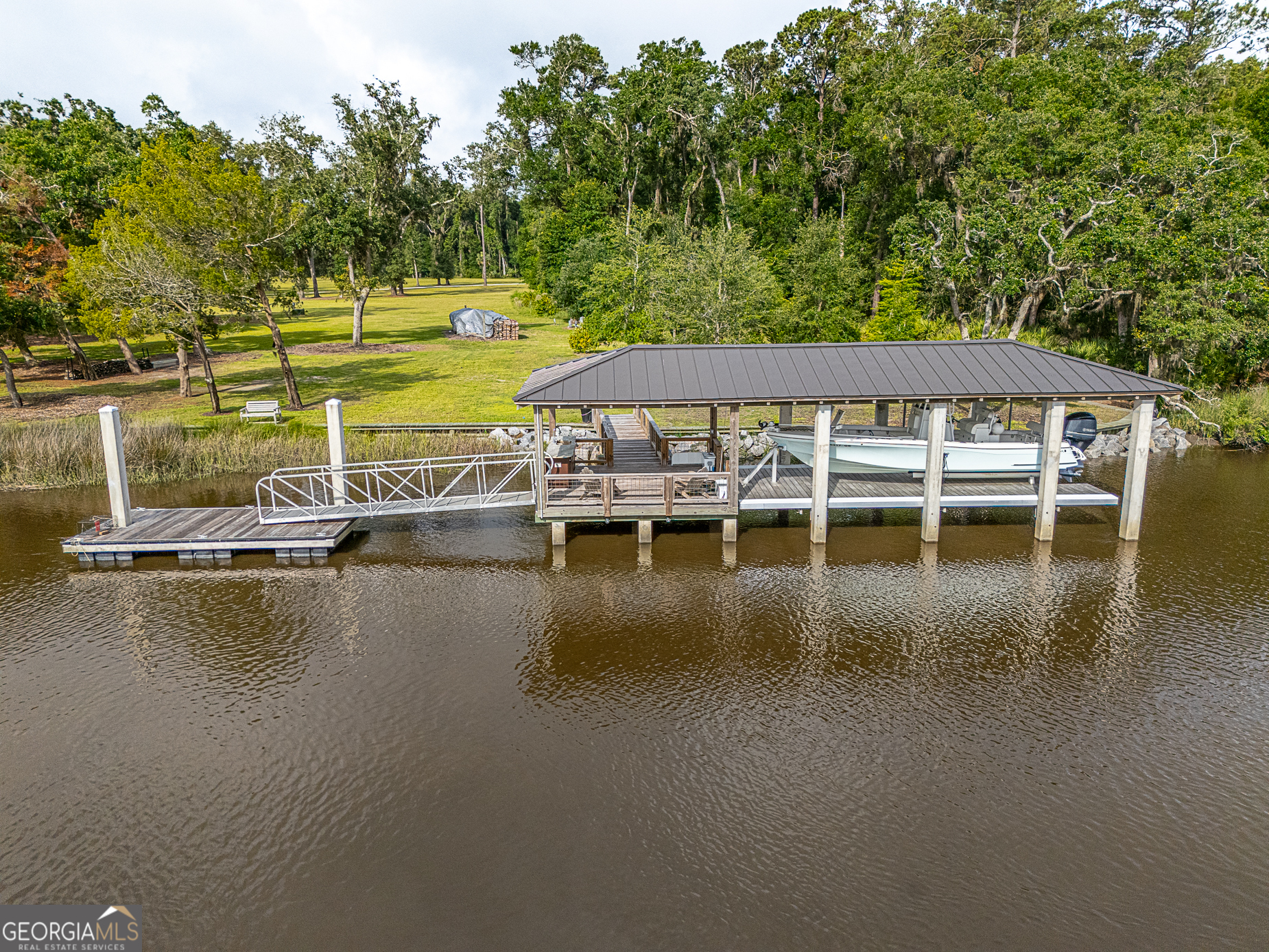 24 Carriage Drive St. Simons Island, GA 31522 - Photo 31 of 67 a view of a lake with house