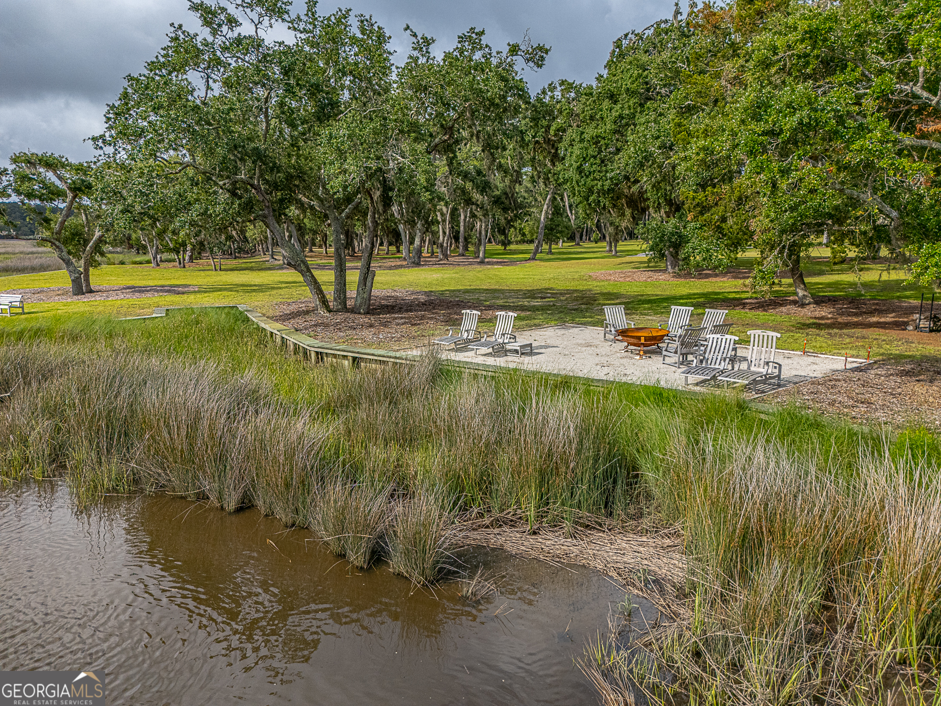 24 Carriage Drive St. Simons Island, GA 31522 - Photo 34 of 67 a view of a lake view with a big yard and large trees