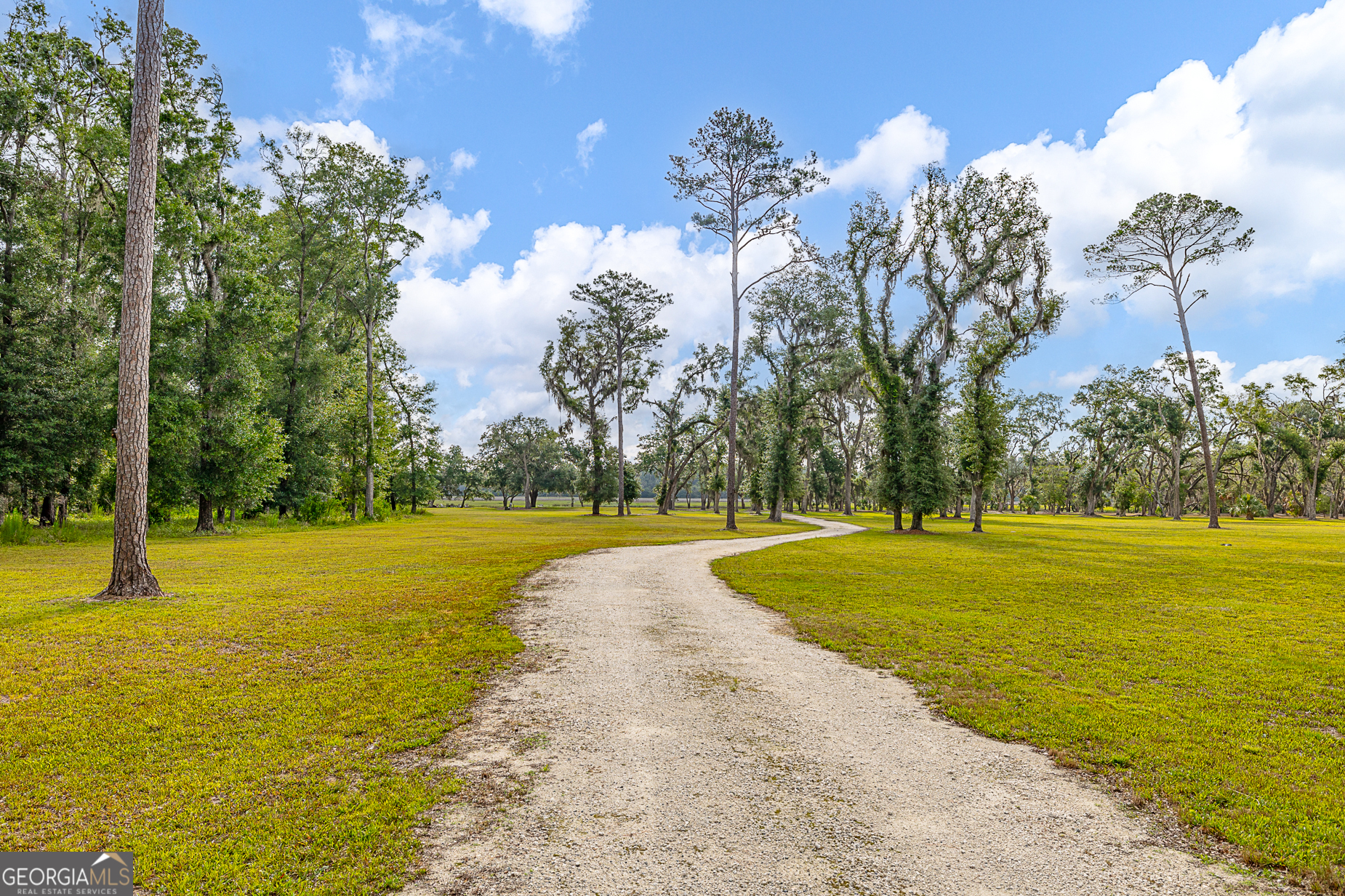 24 Carriage Drive St. Simons Island, GA 31522 - Photo 40 of 67 a view of a swimming pool with an outdoor space and seating area