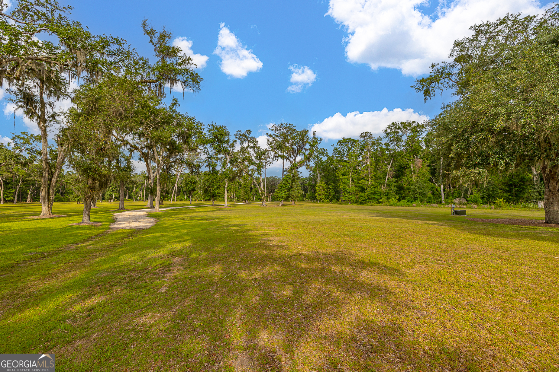 24 Carriage Drive St. Simons Island, GA 31522 - Photo 41 of 67 a view of a swimming pool with an outdoor space and seating