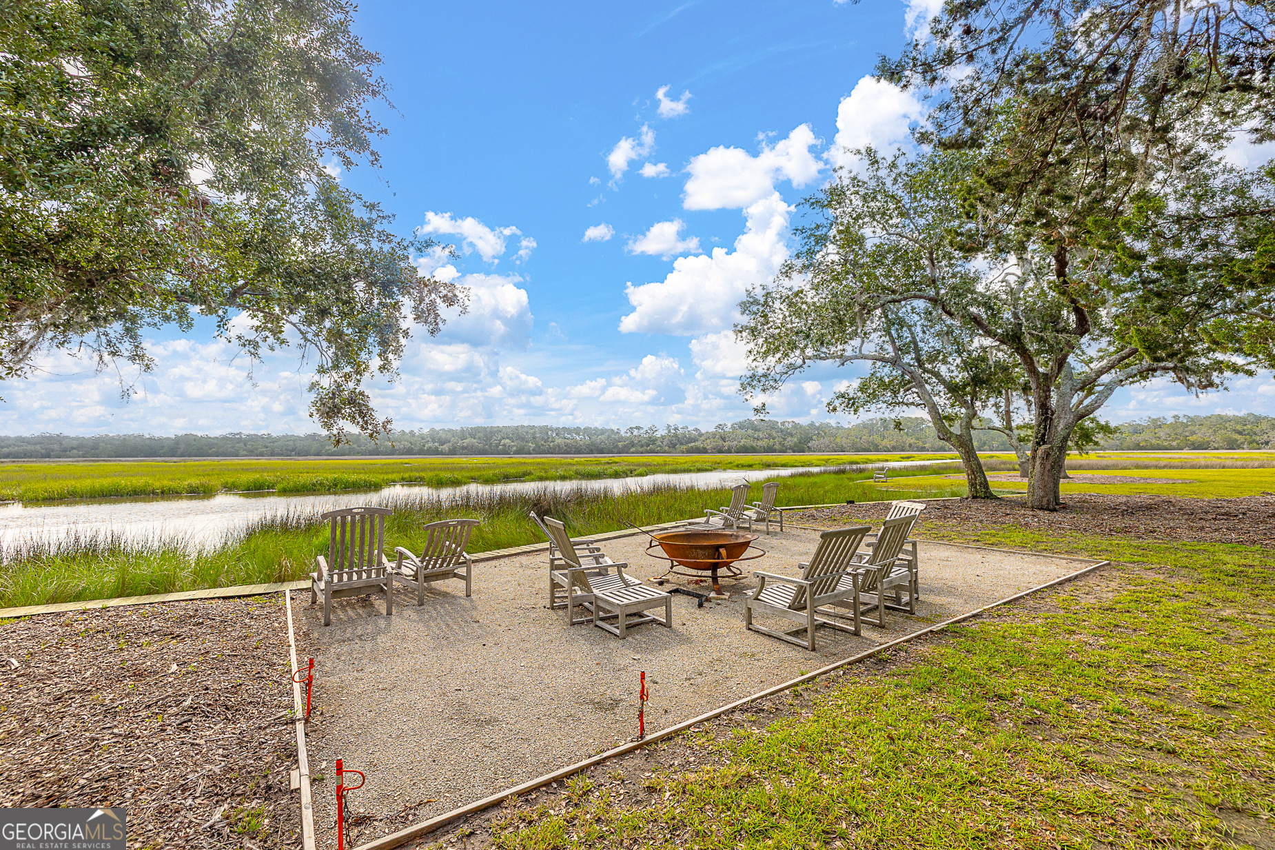 24 Carriage Drive St. Simons Island, GA 31522 - Photo 67 of 67 a view of a swimming pool with a table and chairs in the patio