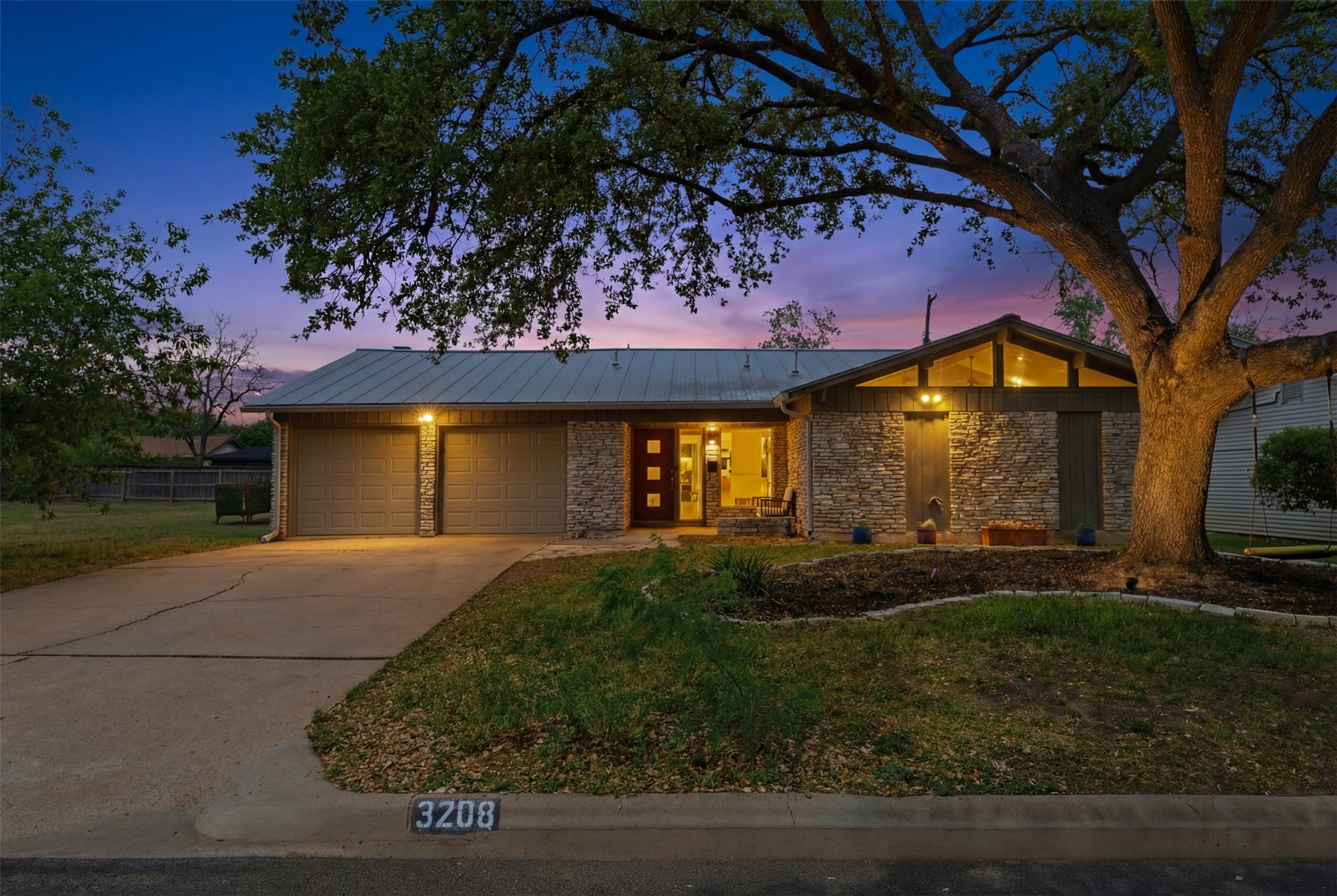 a front view of house with yard and green space