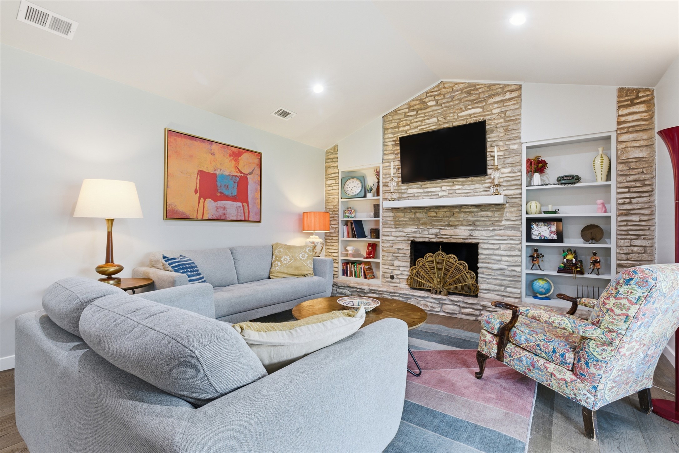 3208 Yellowpine Terrace Austin, TX 78757 - Photo 14 of 35 a living room with furniture a flat screen tv and a fireplace