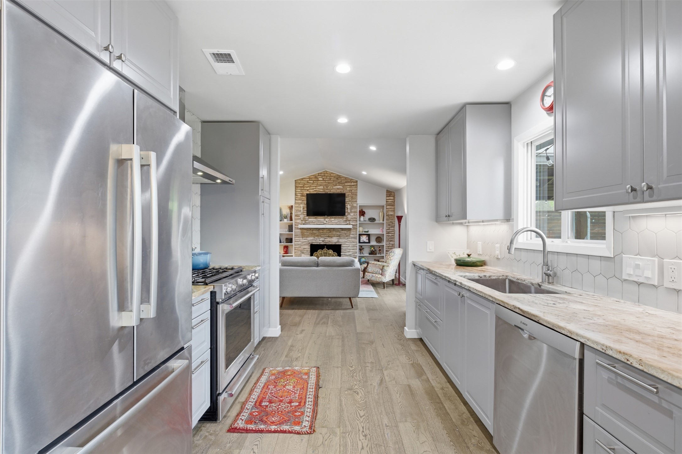 3208 Yellowpine Terrace Austin, TX 78757 - Photo 20 of 35 a large kitchen with stainless steel appliances kitchen island granite countertop a refrigerator and a sink