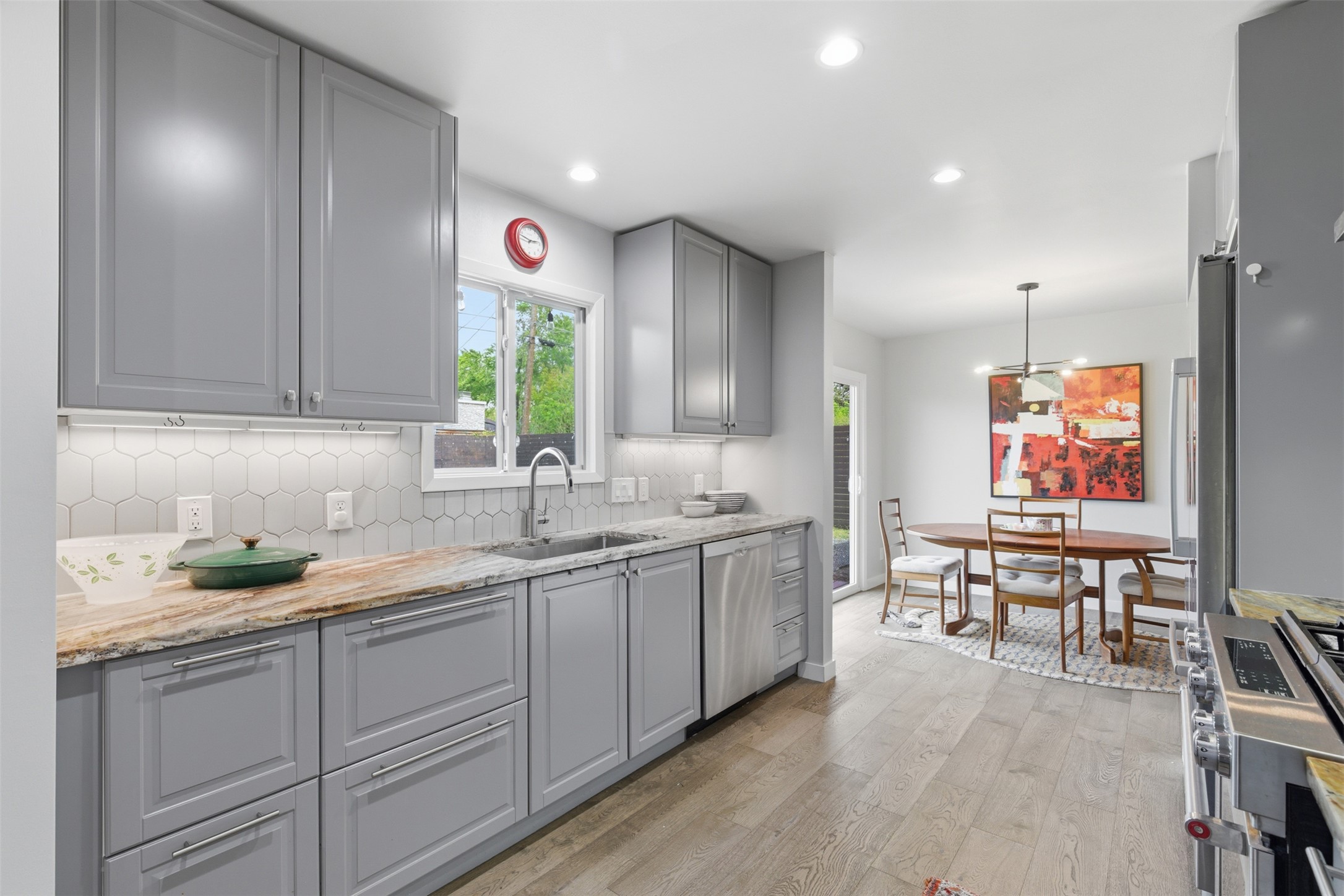 3208 Yellowpine Terrace Austin, TX 78757 - Photo 4 of 35 a very nice looking kitchen with granite countertop a stove a sink a dining table and chairs