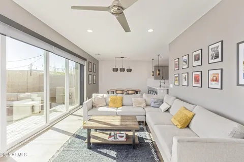 a living room with furniture and a floor to ceiling window