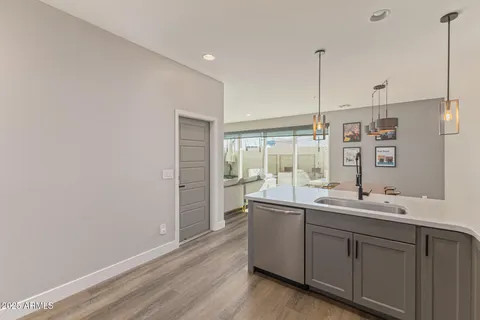 a kitchen with white cabinets stainless steel appliances and a sink