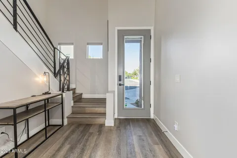 a view of entryway and hall with wooden floor