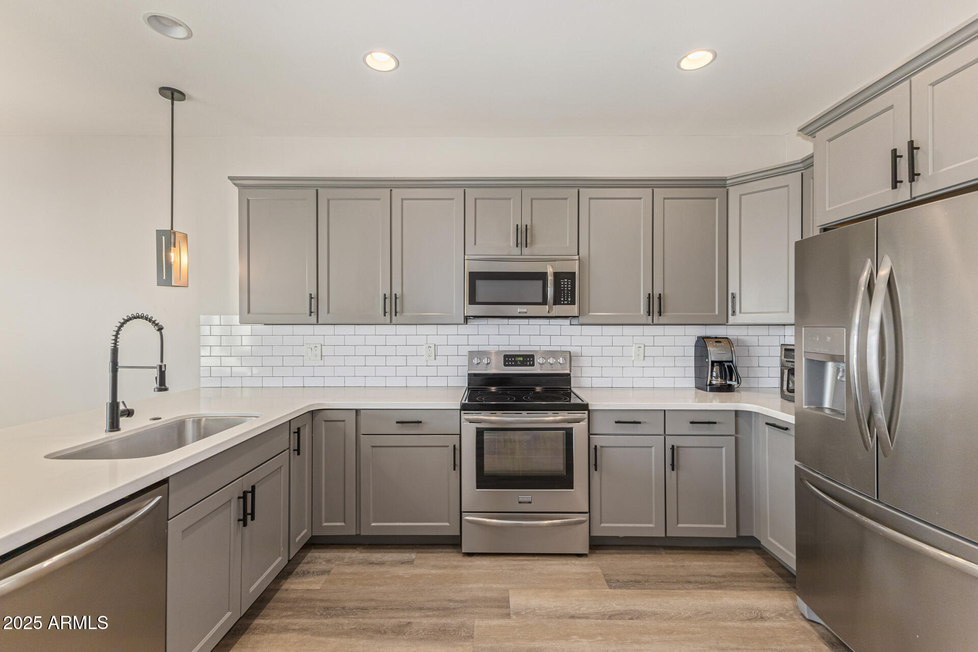 2315 East Pinchot Avenue, Unit 113 Phoenix, AZ 85016 - Photo 21 of 54 a kitchen with white cabinets stainless steel appliances and a sink