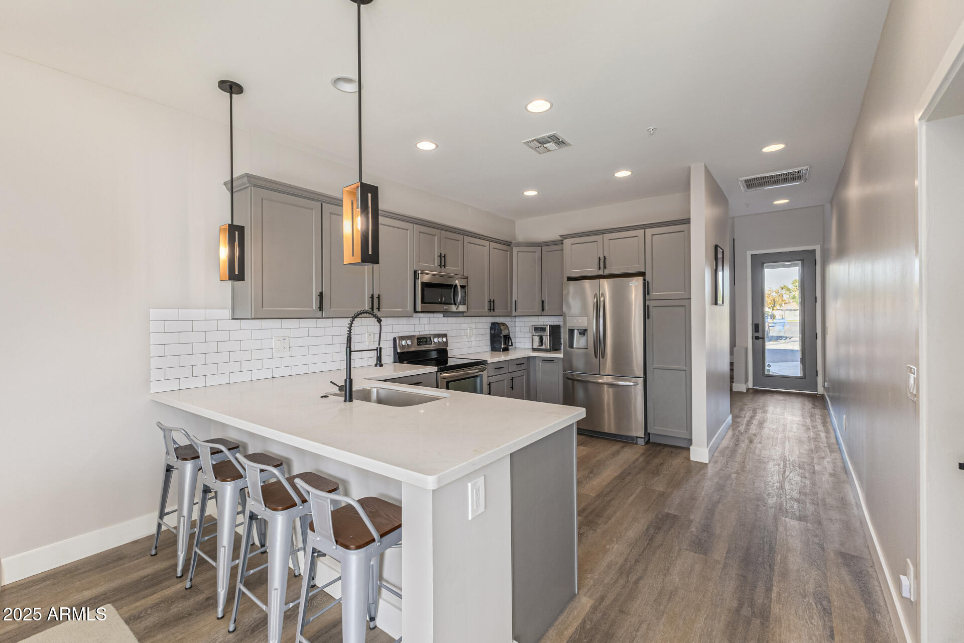 2315 East Pinchot Avenue, Unit 113 Phoenix, AZ 85016 - Photo 22 of 54 a kitchen with stainless steel appliances a sink stove and refrigerator