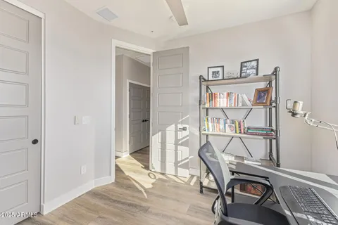 a view of empty room with wooden floor