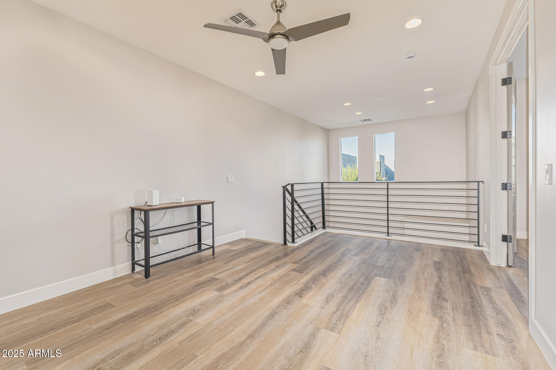 2315 East Pinchot Avenue, Unit 113 Phoenix, AZ 85016 - Photo 33 of 54 a view of a livingroom with wooden floor and a ceiling fan