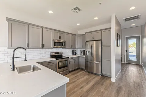 a spacious bathroom with a double vanity sink and a mirror