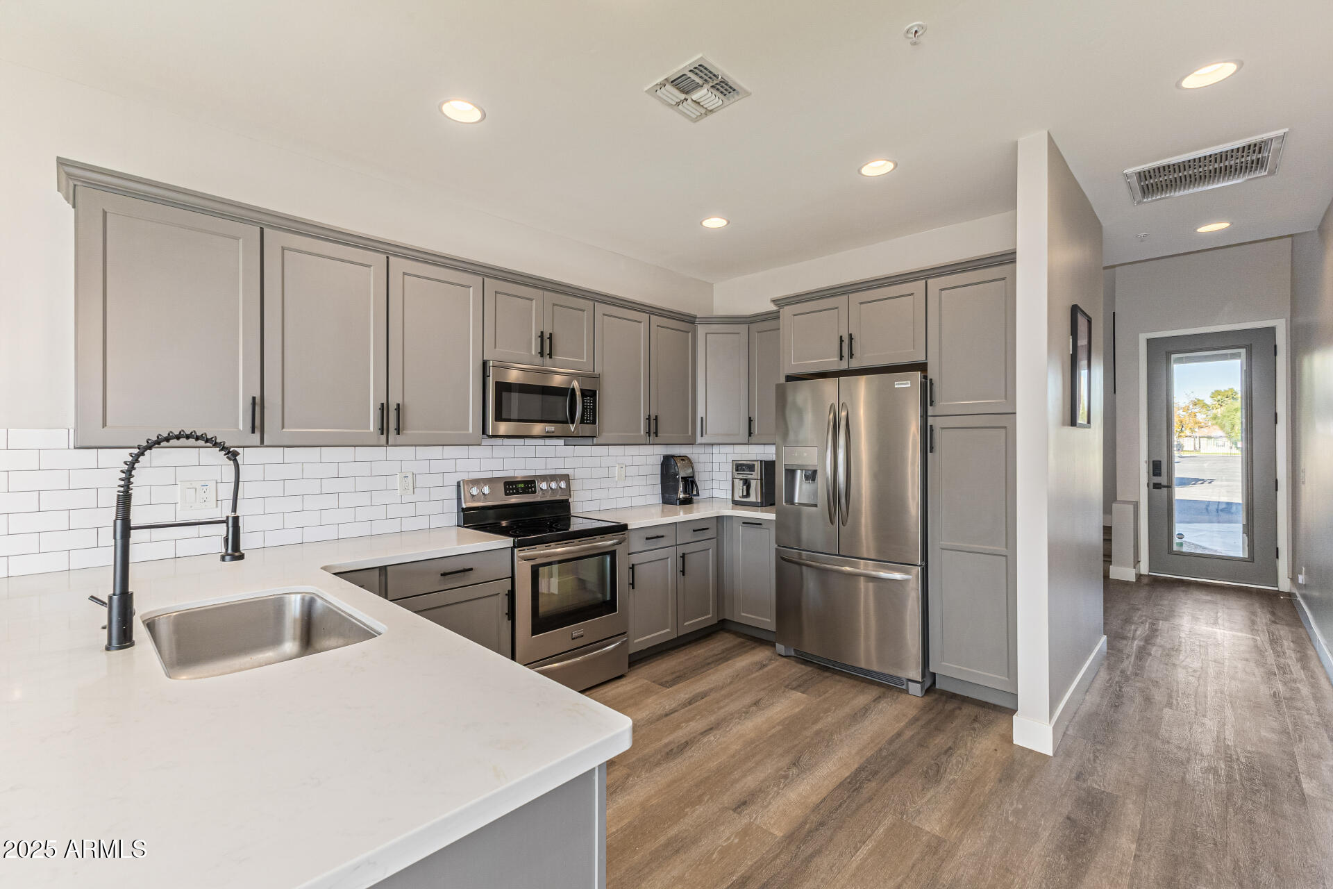 2315 East Pinchot Avenue, Unit 113 Phoenix, AZ 85016 - Photo 7 of 54 a kitchen with refrigerator cabinets and wooden floor