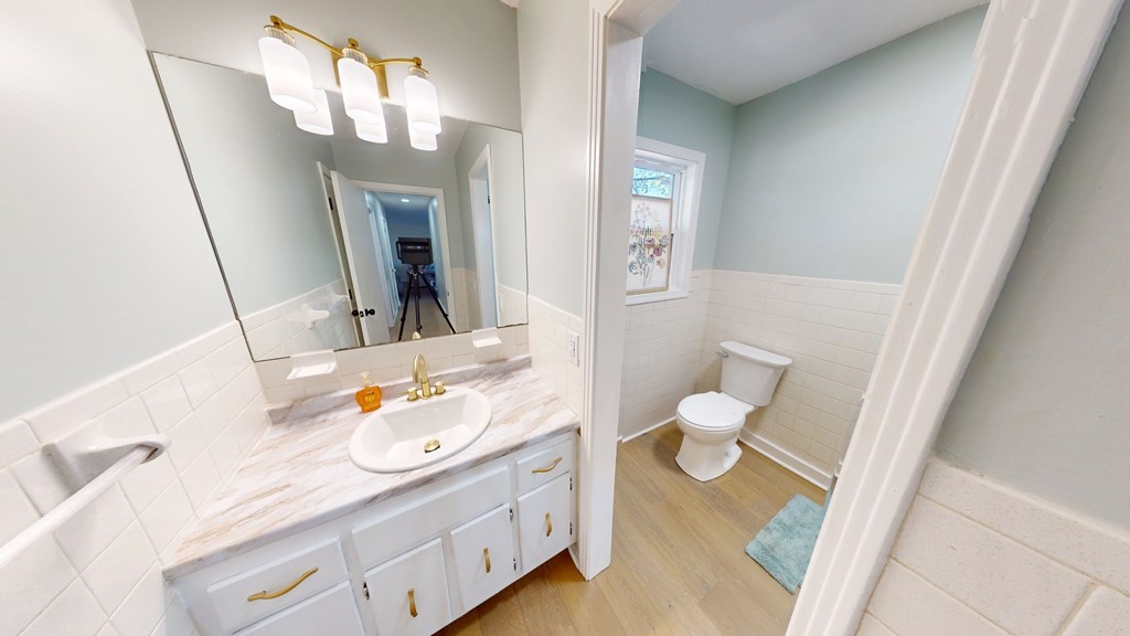 506 Lankford Road Paris, TN 38242 - Photo 12 of 23 a bathroom with a granite countertop sink toilet and a mirror