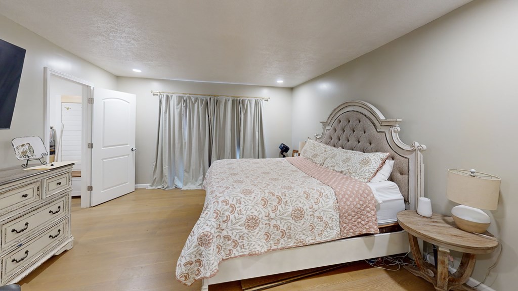 506 Lankford Road Paris, TN 38242 - Photo 16 of 23 a bedroom with a bed and mirror on dresser