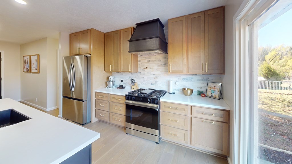 506 Lankford Road Paris, TN 38242 - Photo 18 of 23 a kitchen with white cabinets and stainless steel appliances