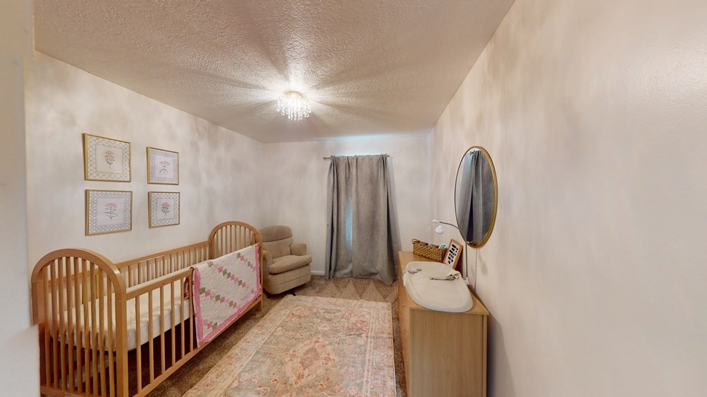 506 Lankford Road Paris, TN 38242 - Photo 9 of 23 a spacious bedroom with a bed and wooden floor