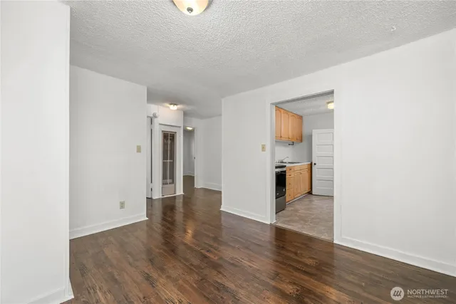 a view of a hallway with wooden floor and closet area