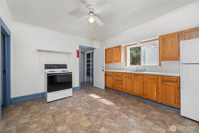 a kitchen with stainless steel appliances a stove a sink and a refrigerator