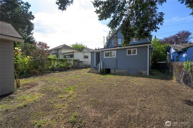 a view of a house with a yard and tree