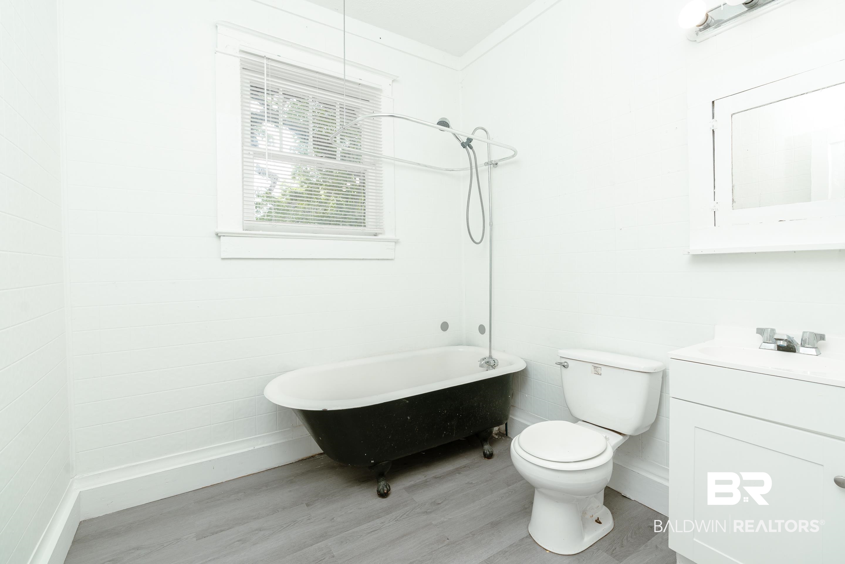 5 North Fulton Street Mobile, AL 36607 - Photo 41 of 55 Bathroom featuring toilet, vanity, and hardwood / wood-style floors