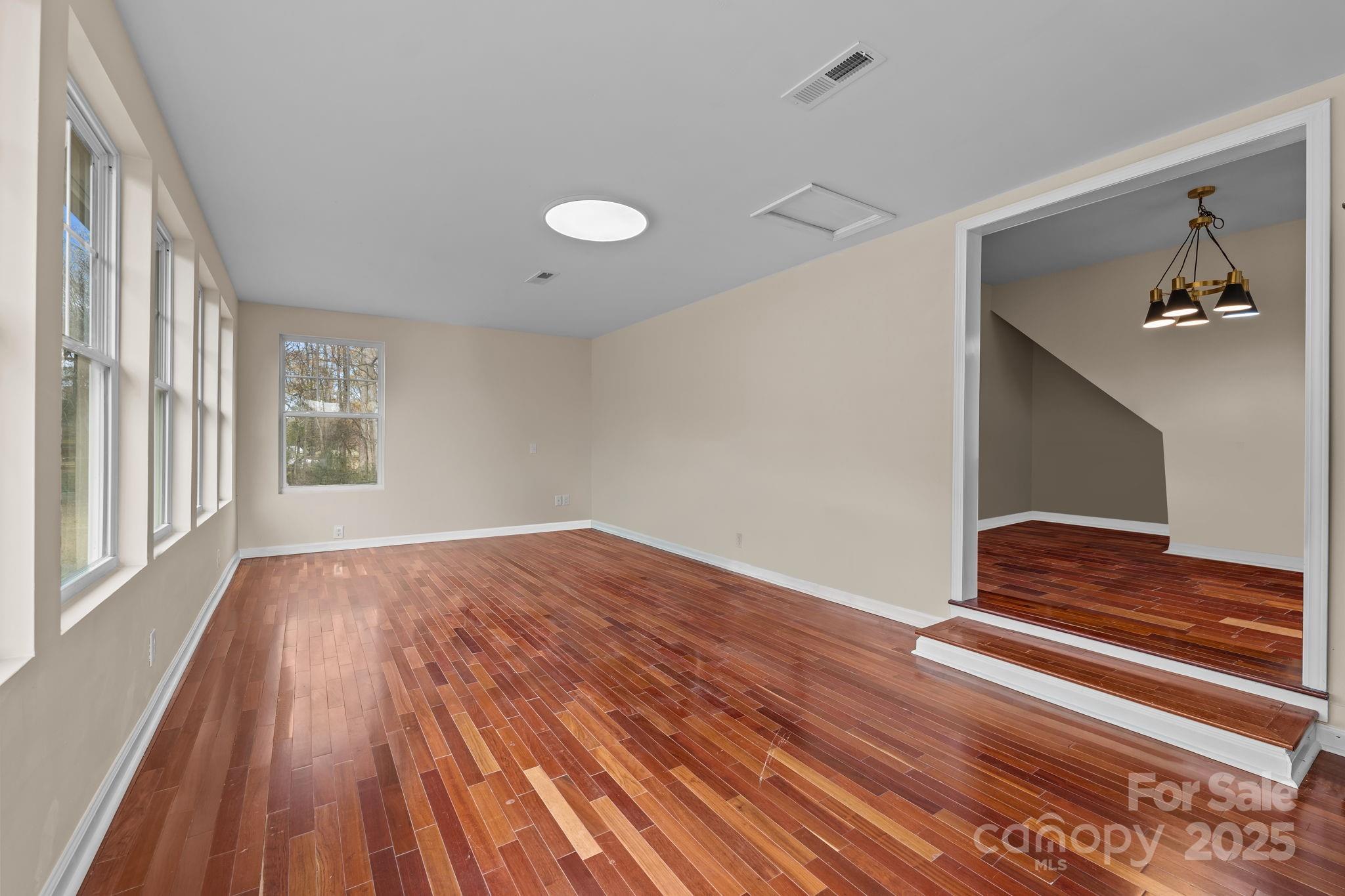 2337 Belmont Road Linwood, NC 27299 - Photo 12 of 46 a view of an empty room with wooden floor and a window