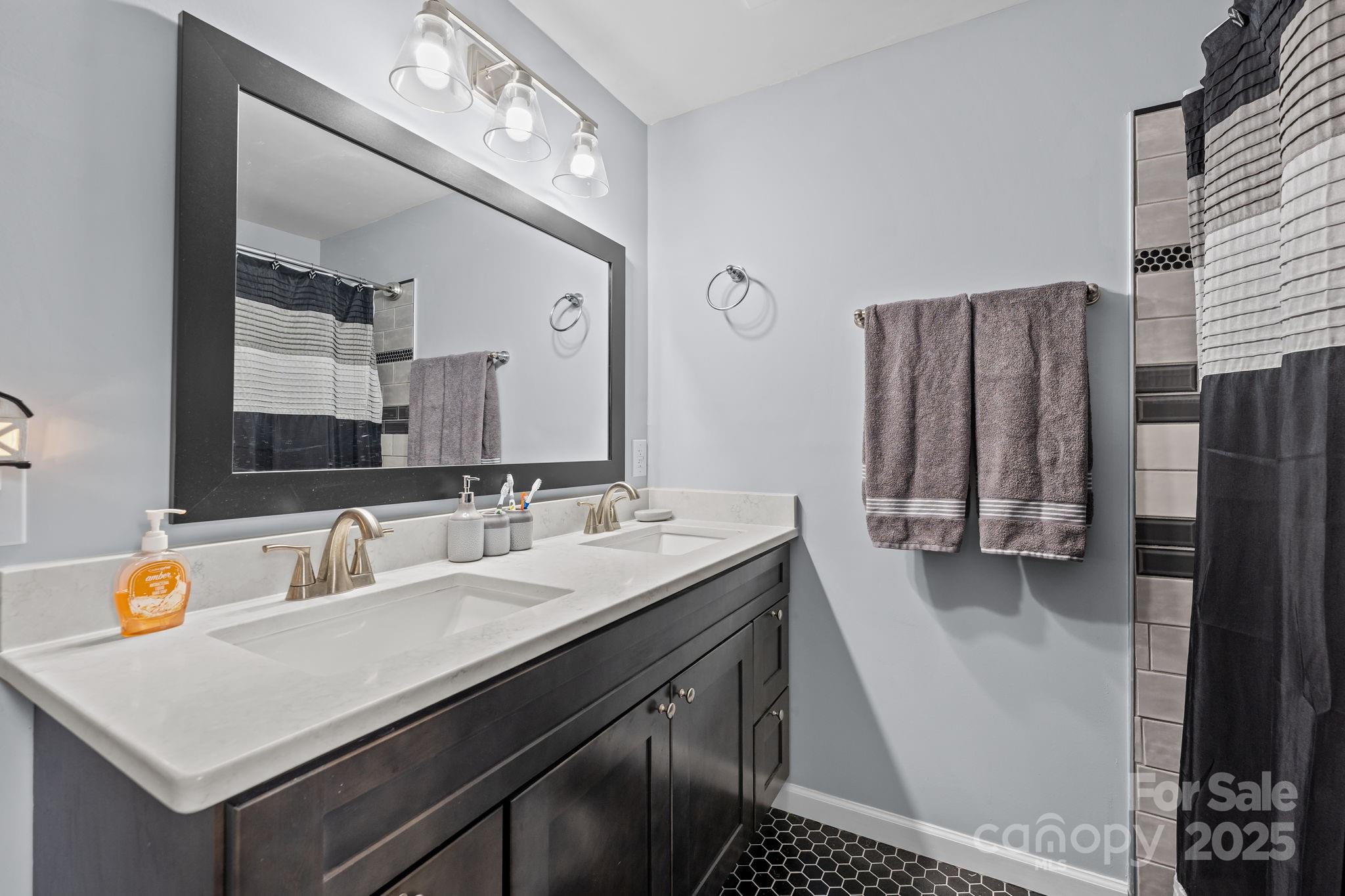 2337 Belmont Road Linwood, NC 27299 - Photo 25 of 46 a bathroom with a sink double vanity and a mirror