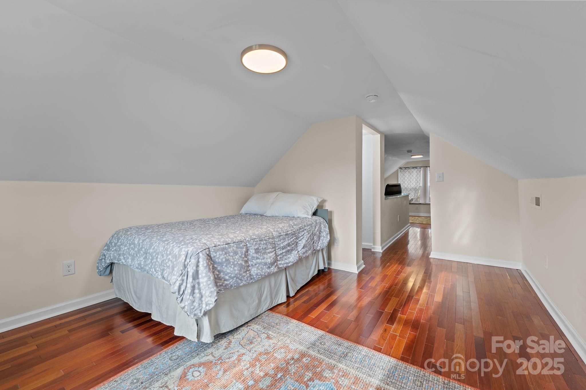 2337 Belmont Road Linwood, NC 27299 - Photo 31 of 46 a bedroom with a bed and wooden floor