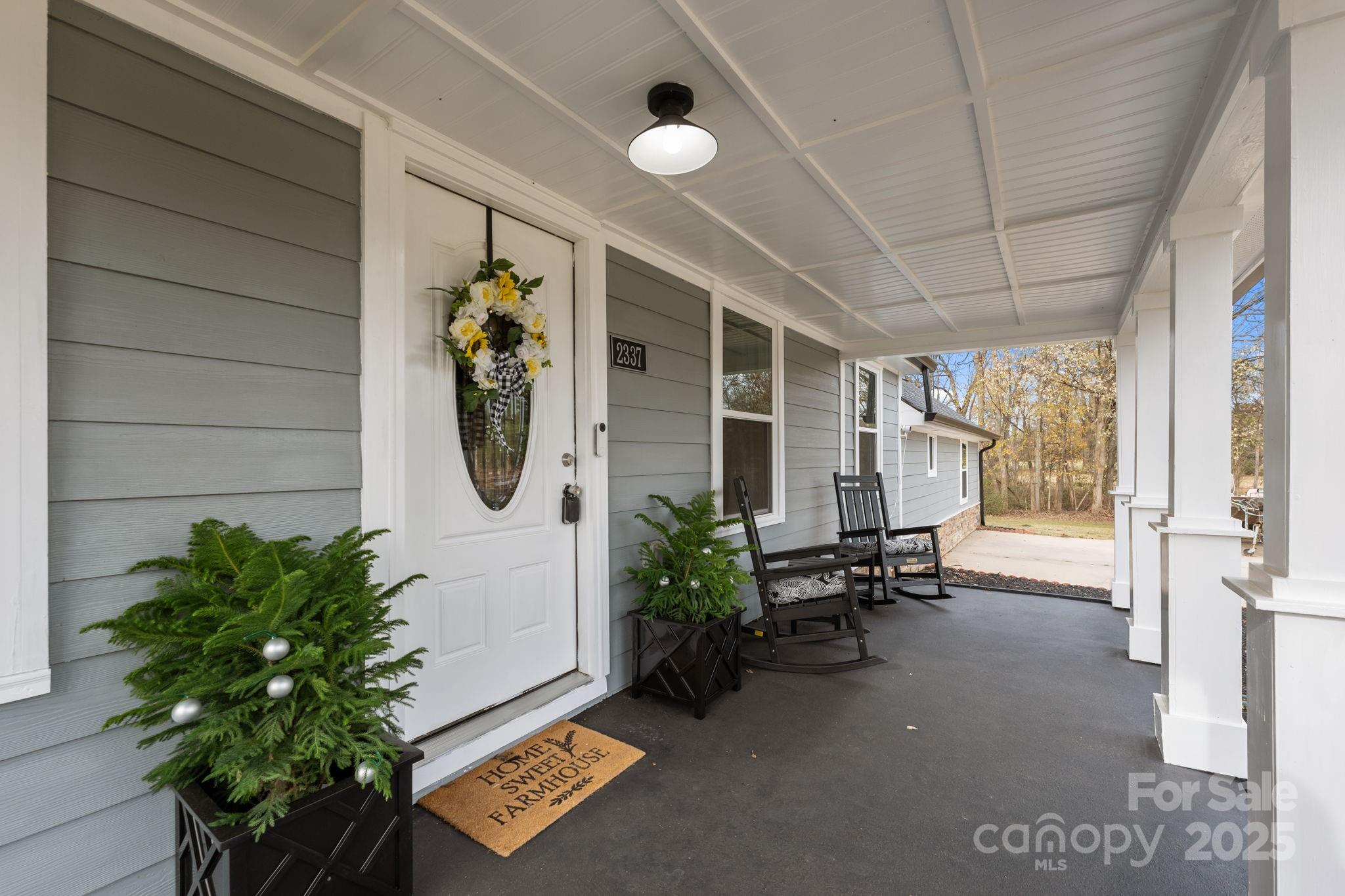 2337 Belmont Road Linwood, NC 27299 - Photo 4 of 46 a hallway with a bench and a potted plant