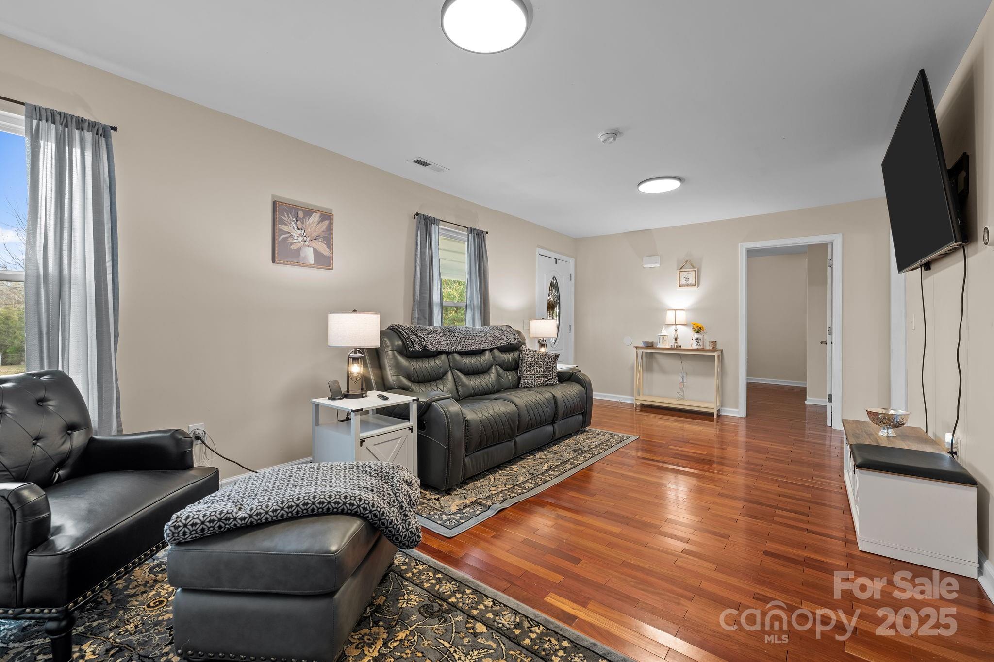 2337 Belmont Road Linwood, NC 27299 - Photo 5 of 46 a living room with furniture and a flat screen tv