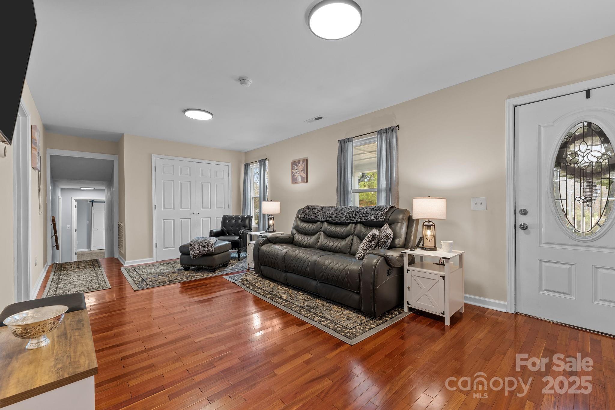 2337 Belmont Road Linwood, NC 27299 - Photo 7 of 46 a living room with furniture and a wooden floor