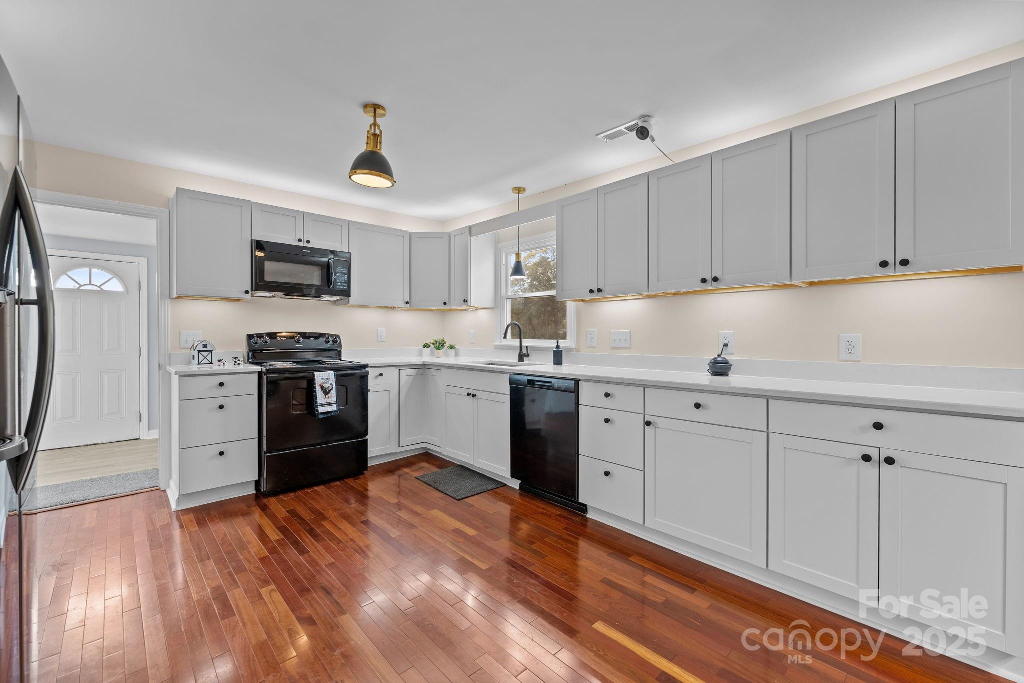 2337 Belmont Road Linwood, NC 27299 - Photo 8 of 46 a kitchen with granite countertop a refrigerator stove top oven and sink