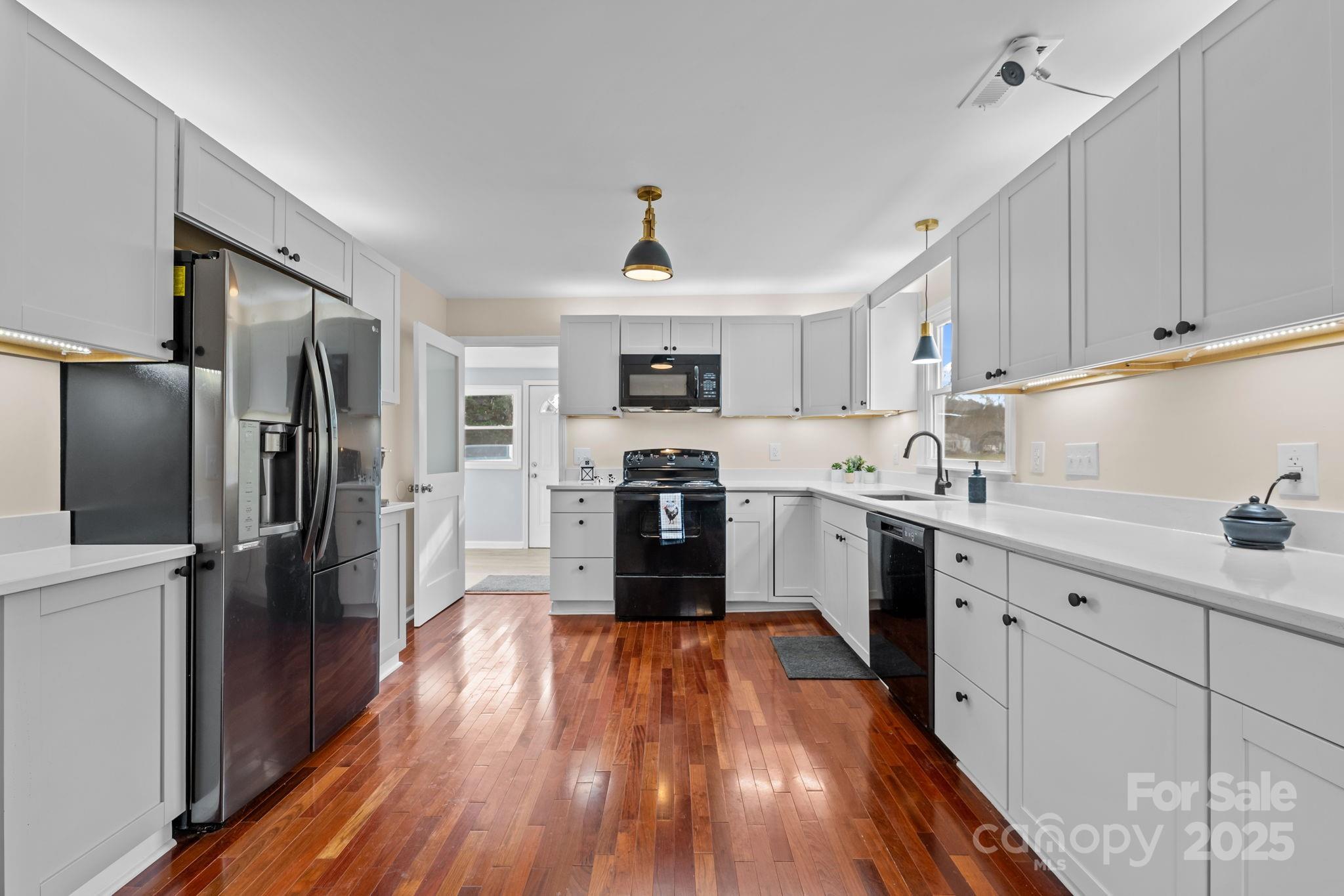 2337 Belmont Road Linwood, NC 27299 - Photo 9 of 46 a kitchen with granite countertop a refrigerator oven a sink dishwasher and a stove top oven