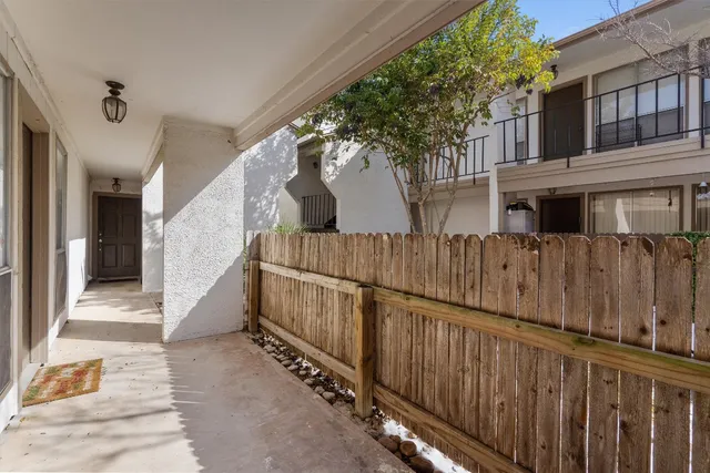 a view of a house with wooden fence