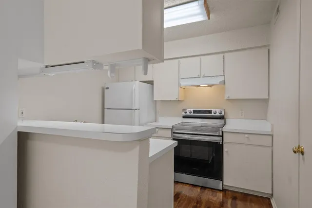 a kitchen with a stove and a refrigerator