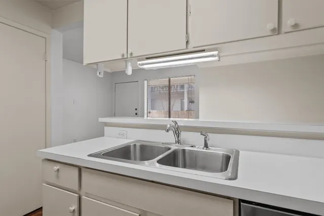a kitchen with a sink and cabinets
