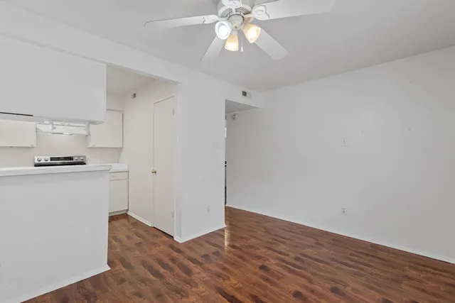 a view of kitchen with hardwood floor and a ceiling fan