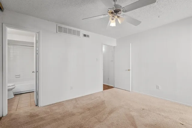 a view of a bathroom with a shower and a toilet